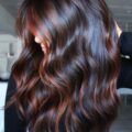 Woman with long hair and copper toned balayage