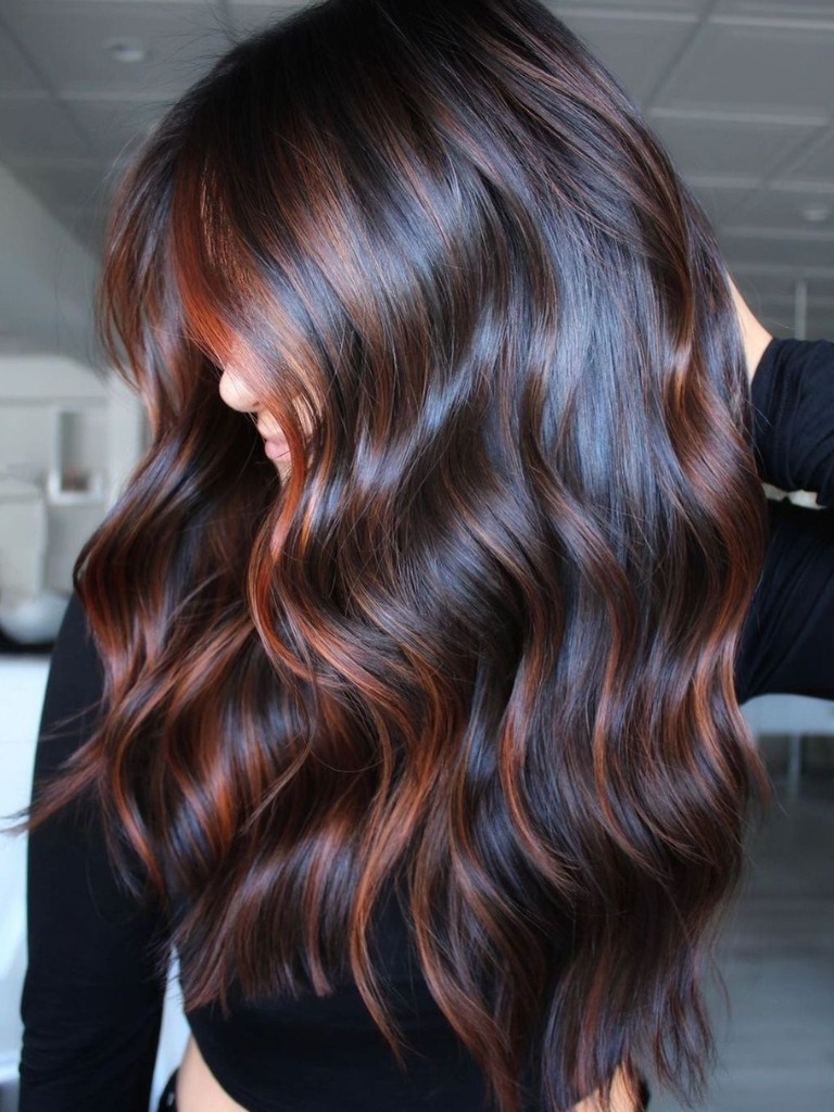 Woman with long hair and copper toned balayage