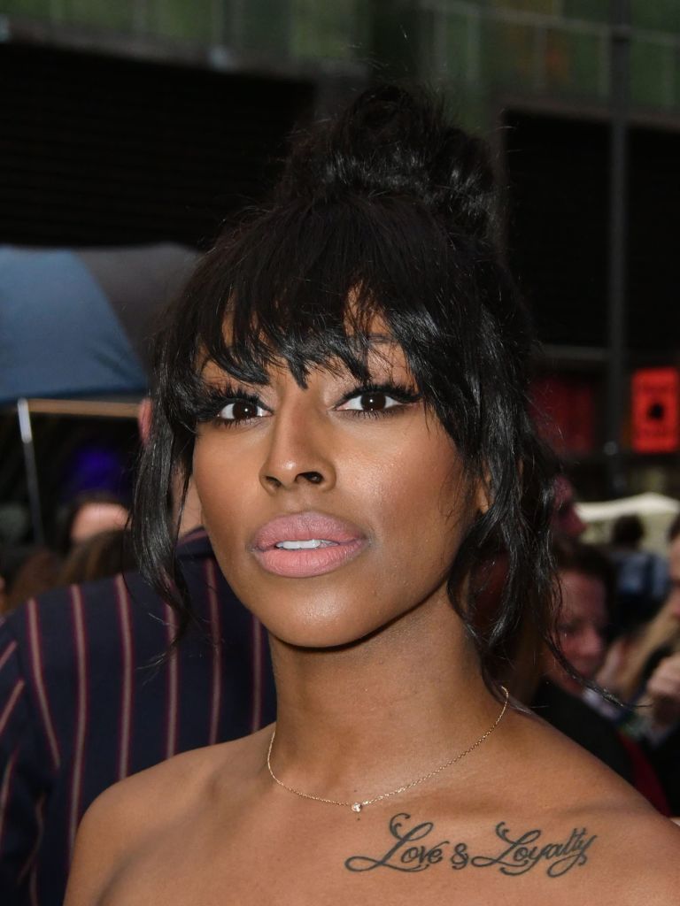 Alexandra Burke with a brow grazing fringe and a high bun