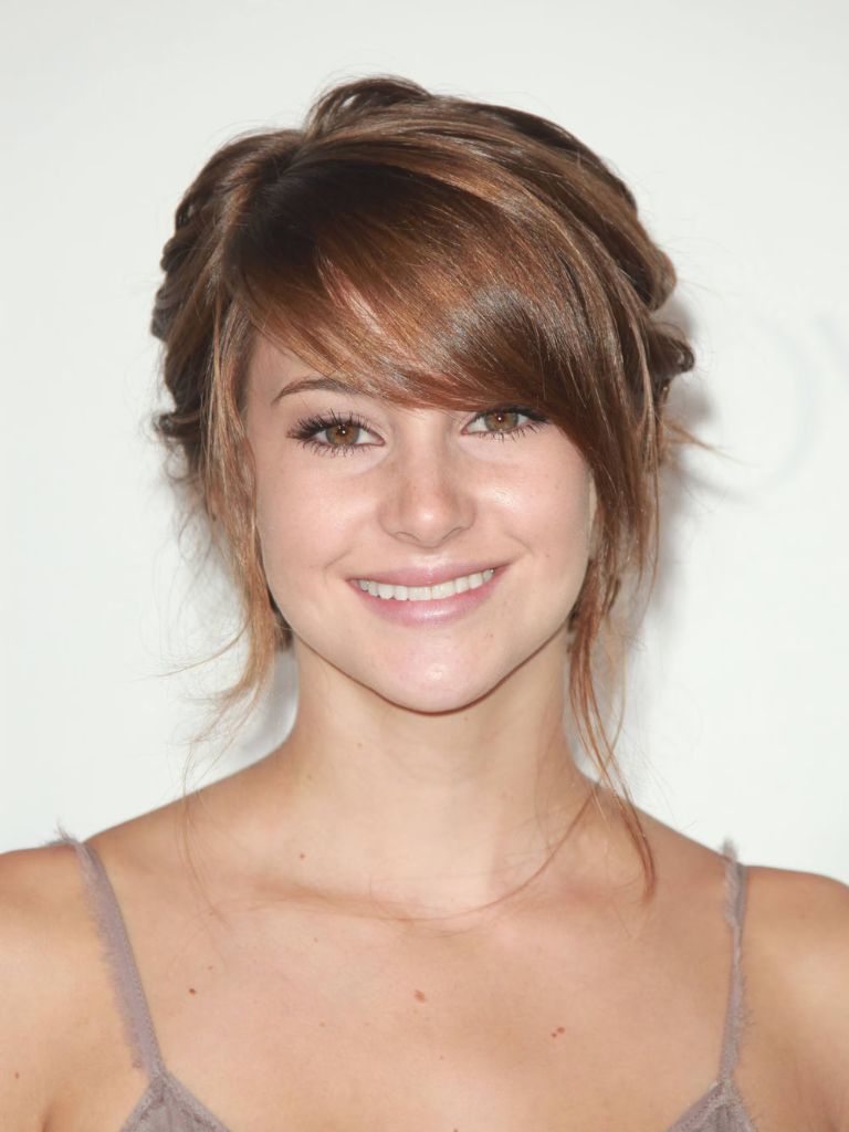 actress shailene woodley with soft brunette swoop bangs in an updo