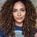 Woman with curly hair and brown balayage