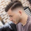 Man with short fade and side sweep hairstyle. Viewed in profile. Good for thinning hair