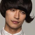 Man with Mushroom haircut with long flicked up side fringe