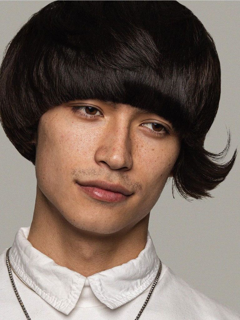 Man with Mushroom haircut with long flicked up side fringe