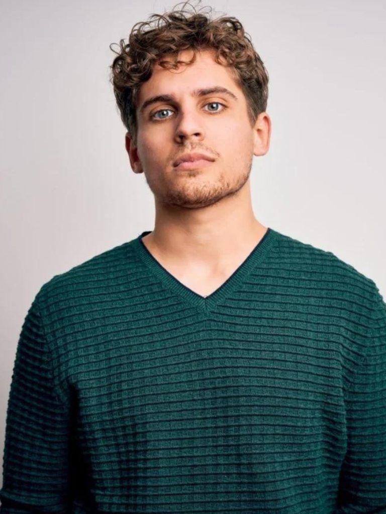 Brown haired man with short curly hair