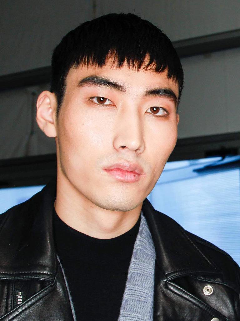 man with short black hair and a French crop hairstyle