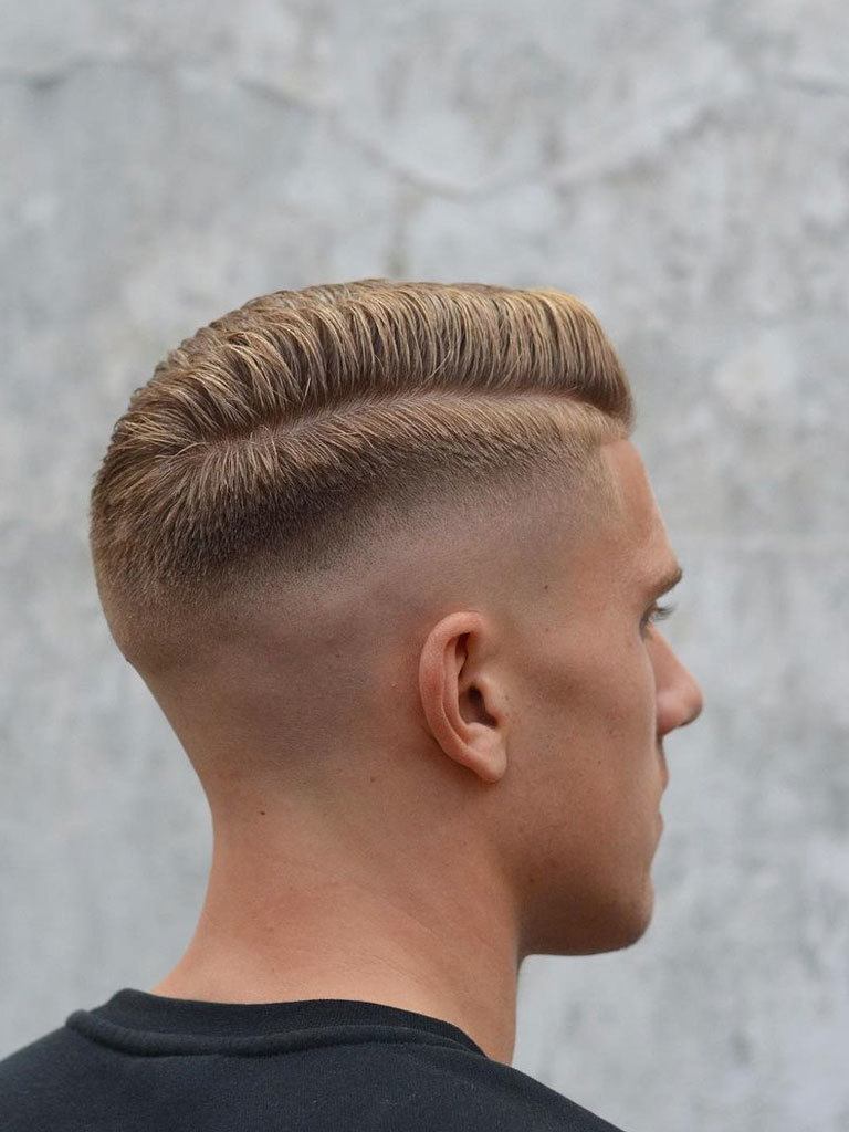 Blond man seen from rear with side combover and taper fade
