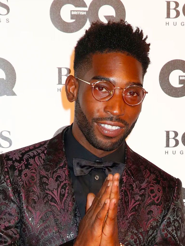 shot of tinie tempah on the GQ Men of the Year Awards red carpet wearing suit, with his hair styled into a high top fade