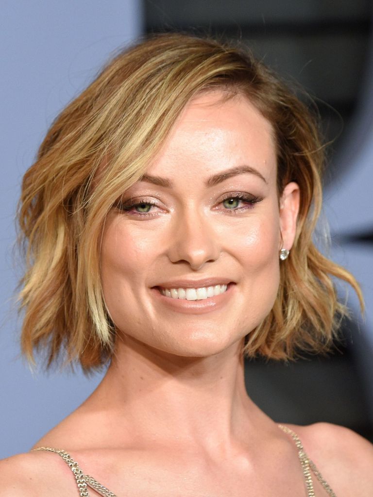 Olivia Wilde golden blonde hair styled in a side parting choppy bob