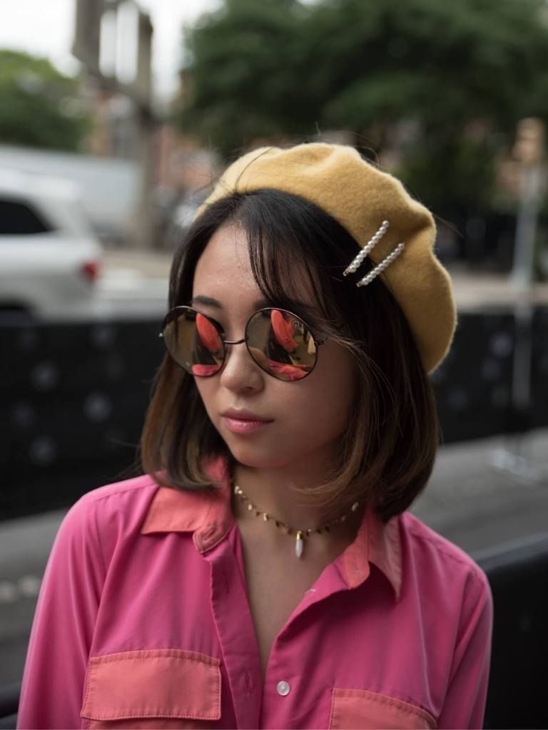 Woman with short Asian hair with side bangs, beret and hair clips