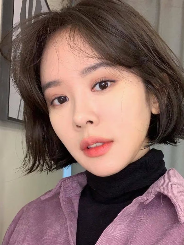 Woman with short Asian hair and wispy bob haircut