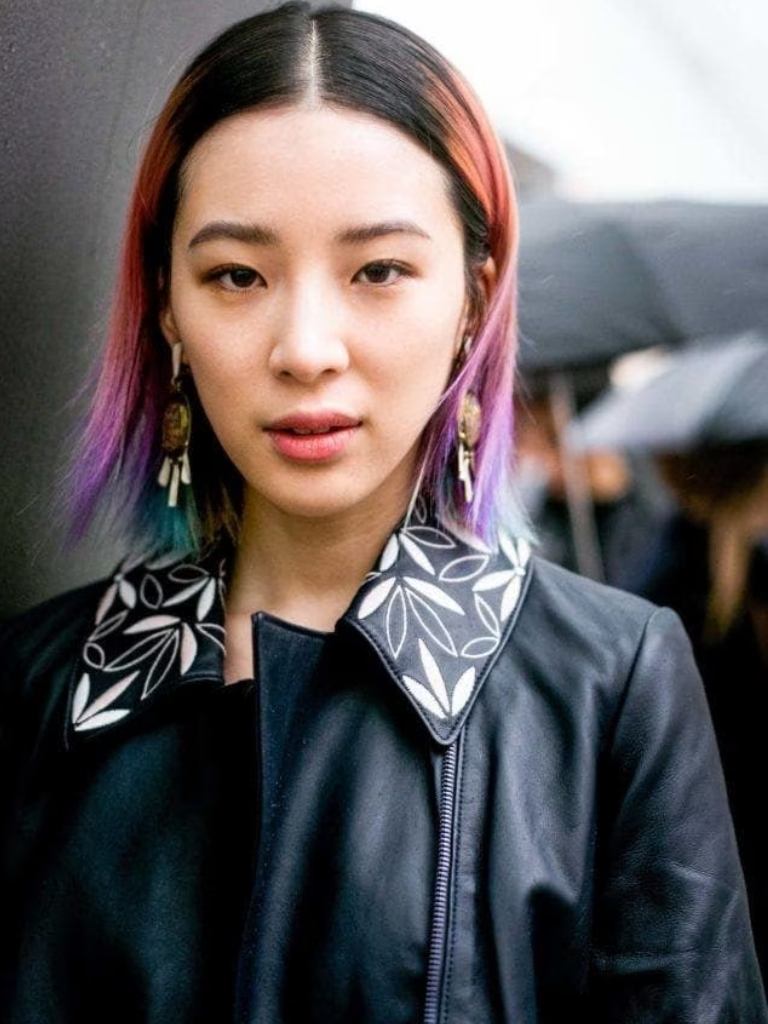 Asian hairstyles: Asian woman with straight multi-coloured long bob wearing a leather jacket.