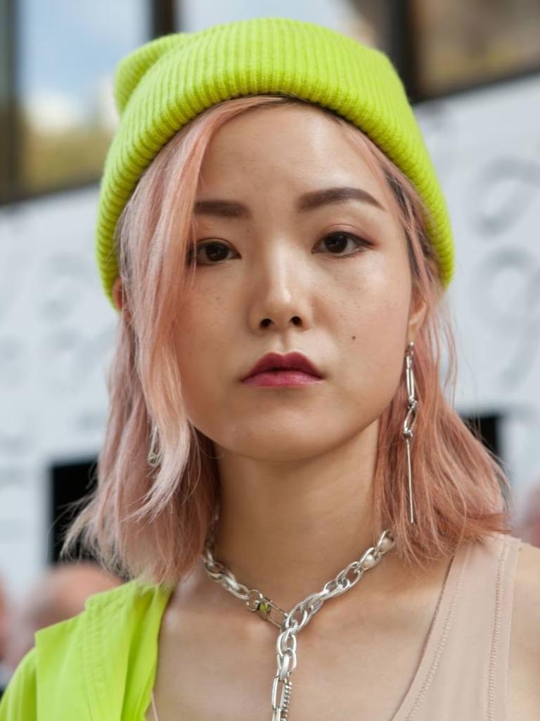 Woman pink shoulder-length Asian hair with neon yellow beanie hat