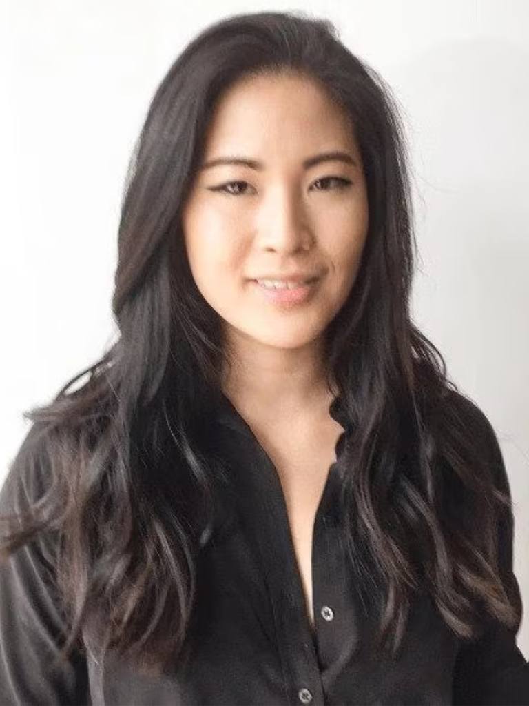 Asian hairstyles: Asian woman with long wavy layered dark brown hair.