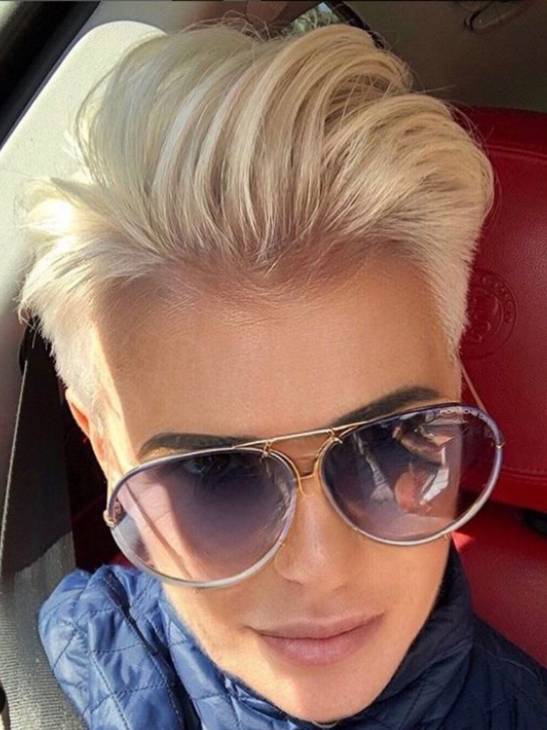 Woman with sleek and slicked back blonde pixie
