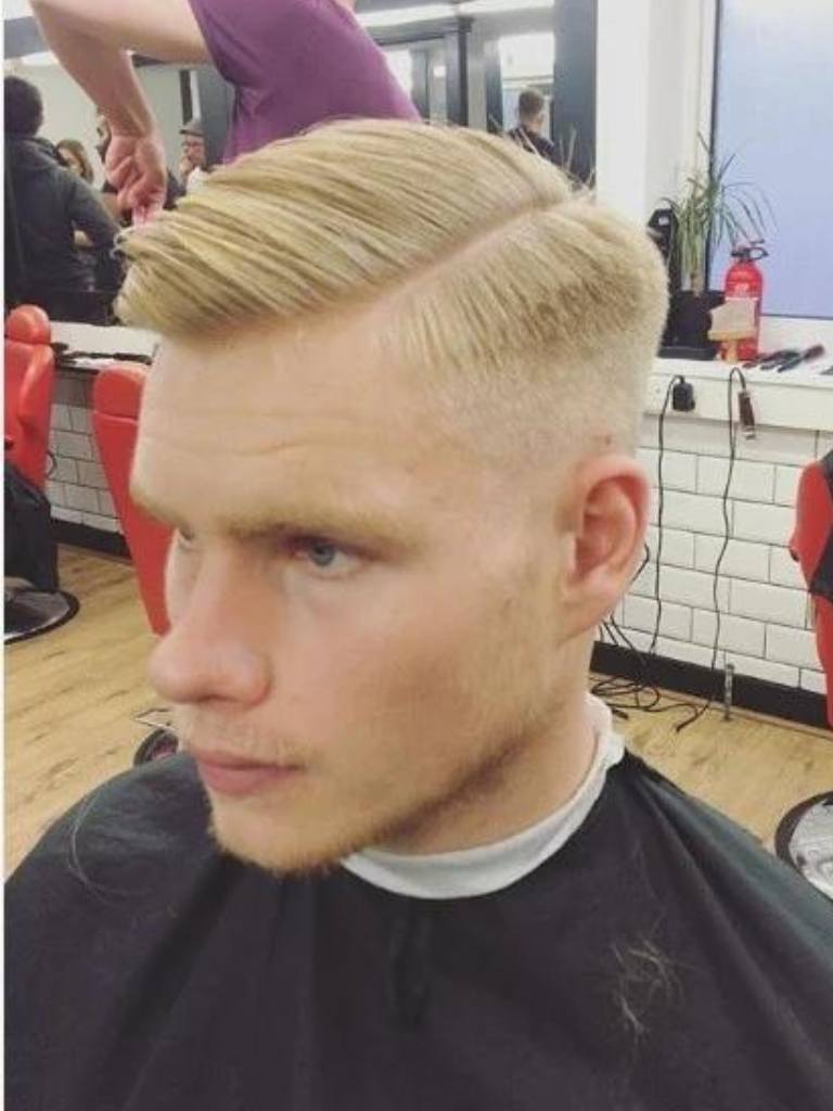 Taper comb over haircut: Blonde man with a comb over and taper fade, with a shaved parting