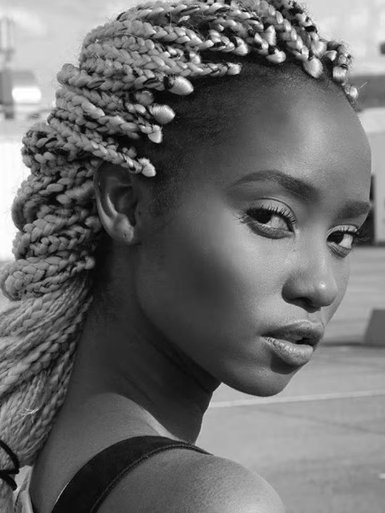 side shot of woman with braided medium sized box braid hairstyle