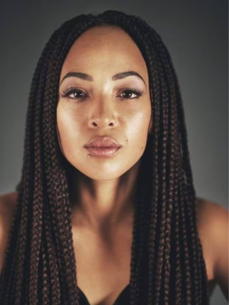 close-up of a woman with medium brown box braids