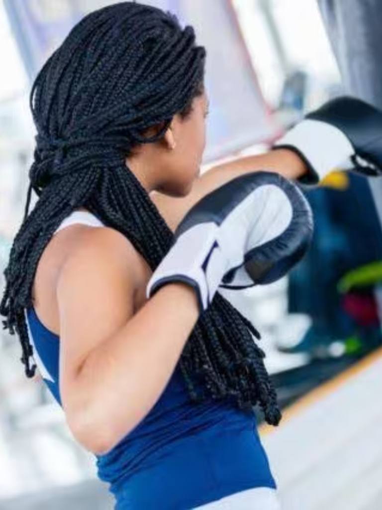 Woman with box braids doing boxing