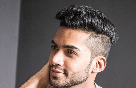 man with a faded undercut hairstyle looking away from the camera