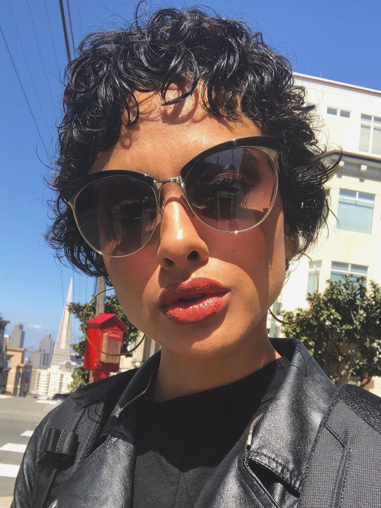 Short pixie cut with curls. Woman in San Francisco posing wearing glasses