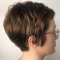 Woman with a brown balayage on short pixie cut