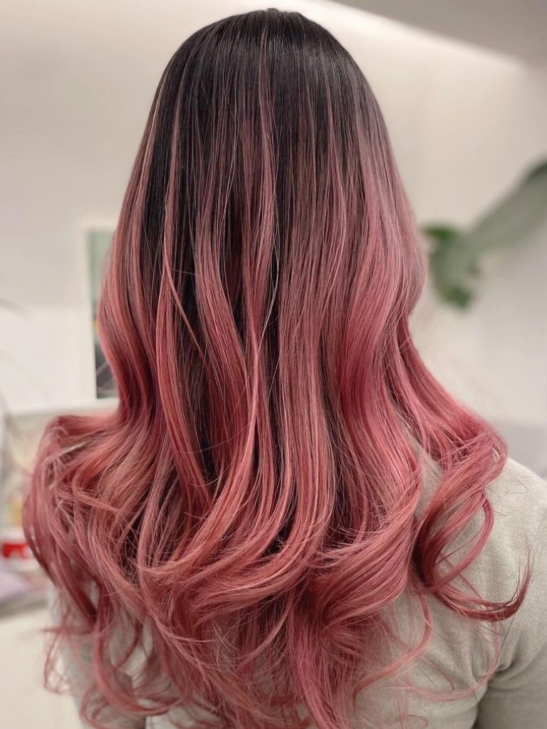 person with pink balayage on brown hair