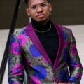 Goodlooking Black Man wearing a bright jacket sporting the gentleman's mohawk with fade.