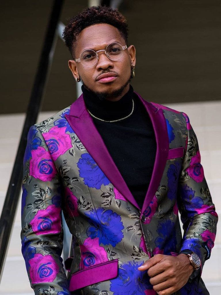 Goodlooking Black Man wearing a bright jacket sporting the gentleman's mohawk with fade.