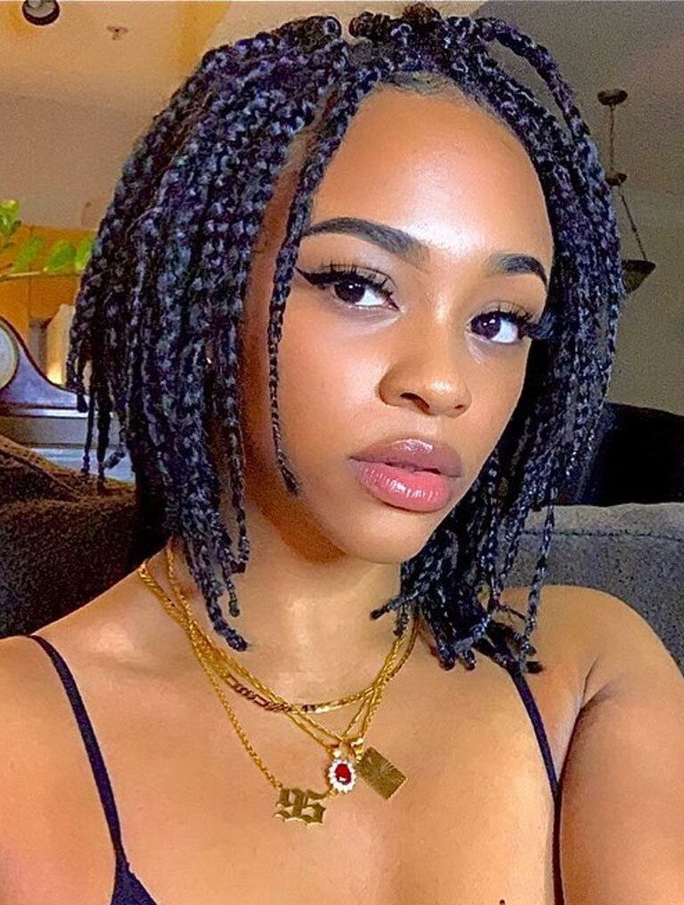 black woman with bob length box braids on natural hair