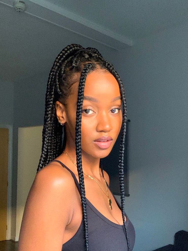 Long box braids hairstyles: Beautiful black woman with long box braids in a half-up half-down style