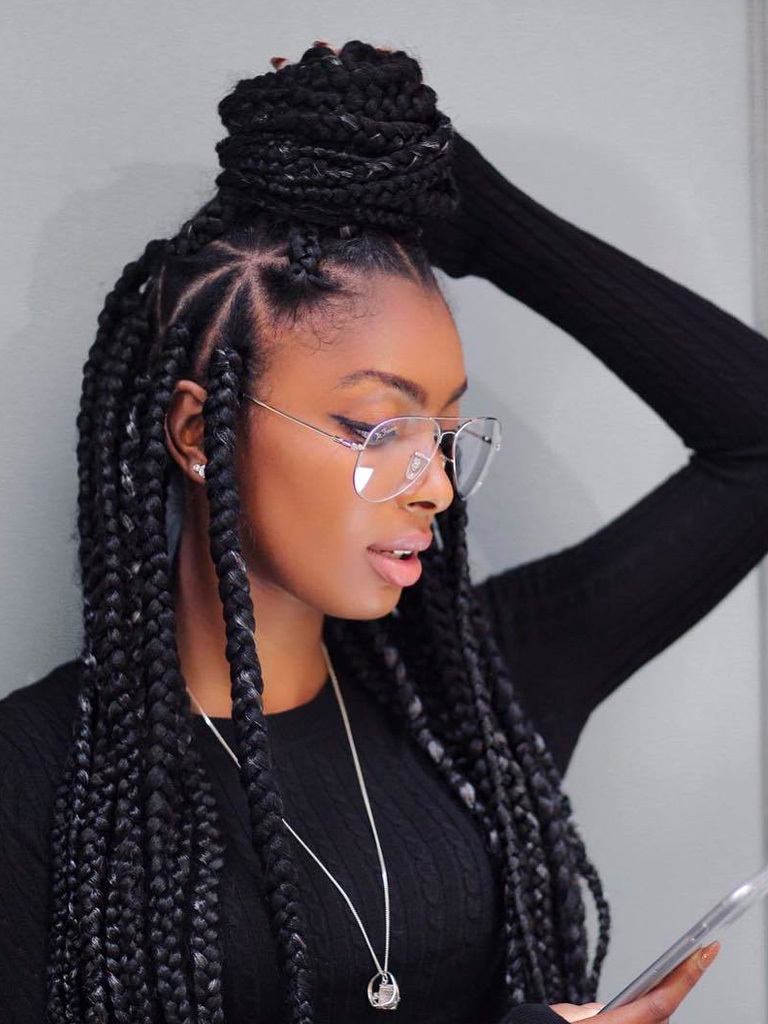 woman with half-up, half-down box braids with triangle partings