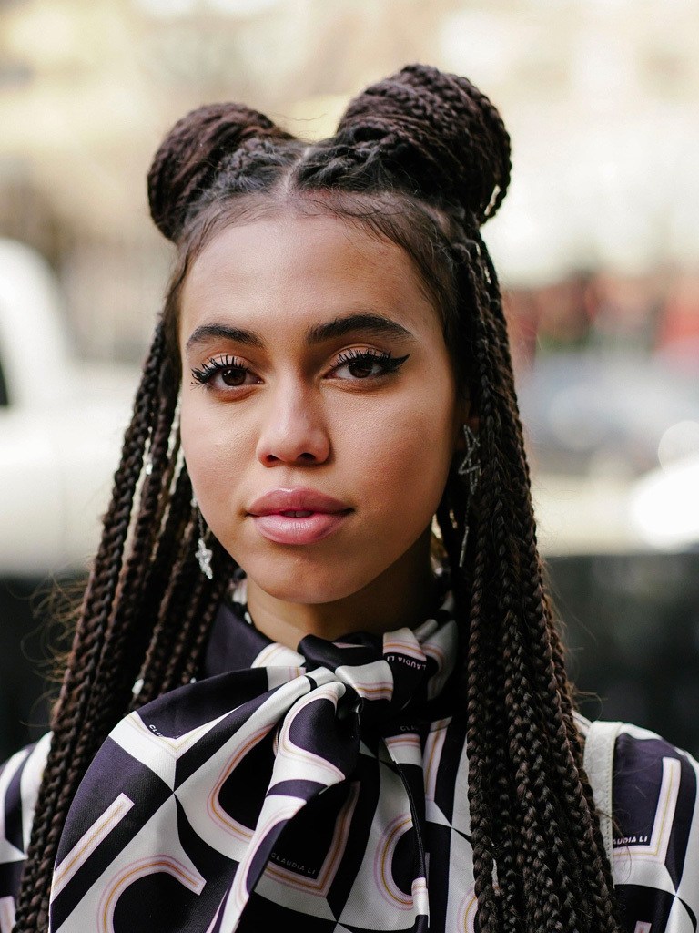 Long box braids hairstyles: woman with long box braids in a half up half down space bun style