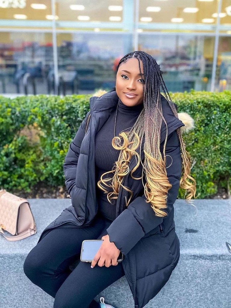 Woman with long box braids with ombre blond curls