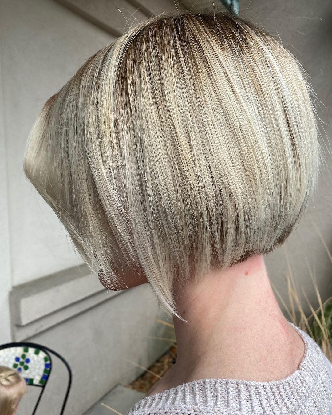 Woman with blonde hair and layered bob haircut
