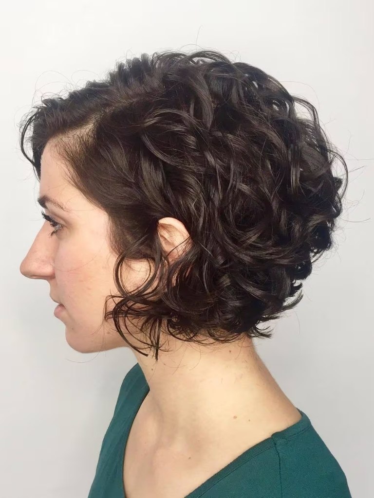 Side profile of woman with curly graduated bob