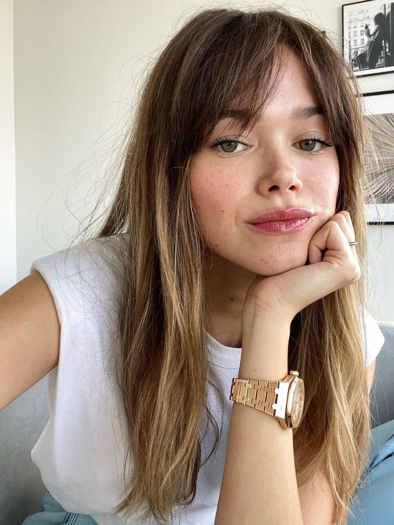 woman with long brunette hair and choppy bangs