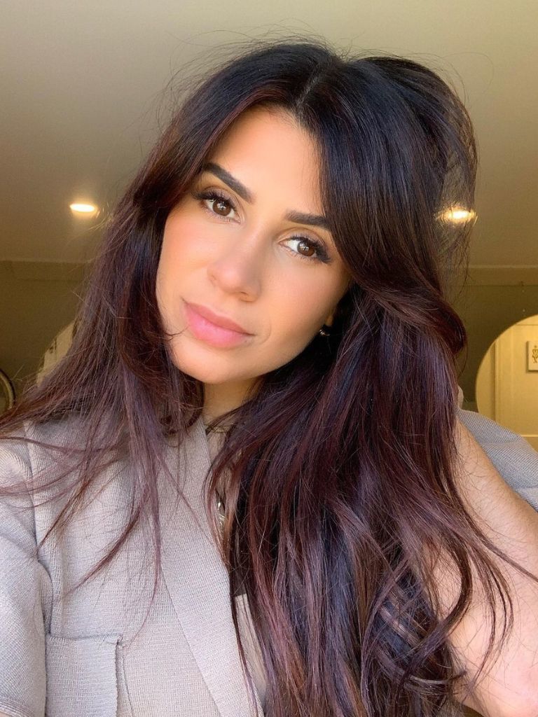woman with long brunette hair in a chestnut balayage
