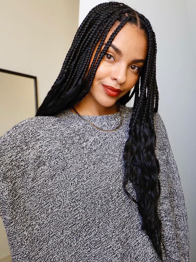 Young black woman with beautiful long knotless braids with curly ends