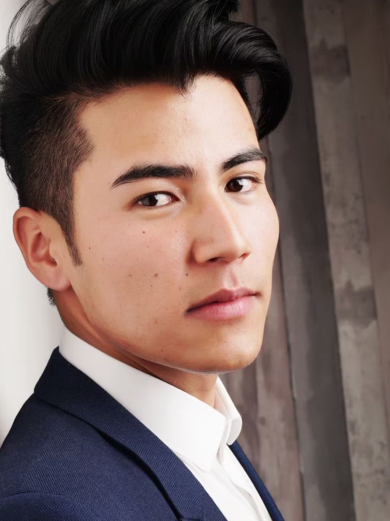 Man with long side swept fringe with subtle undercut taper
