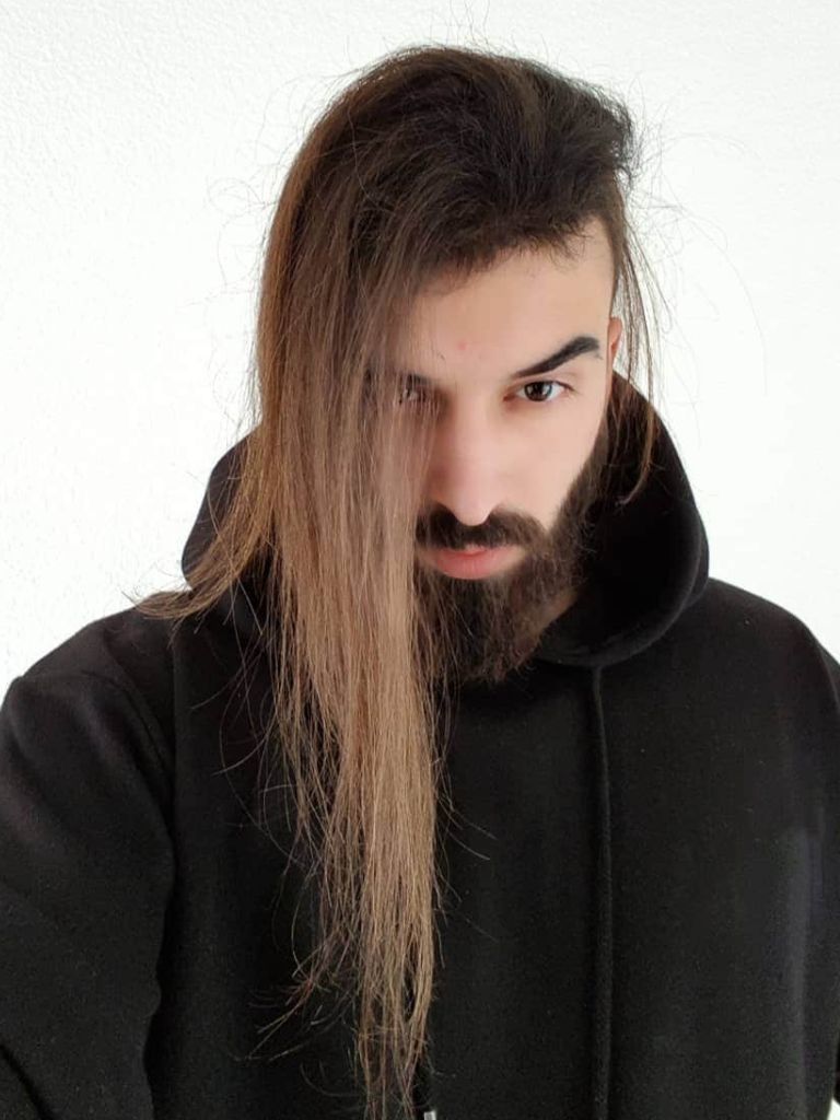 Man with long straight hair and bald side undercut hairstyle