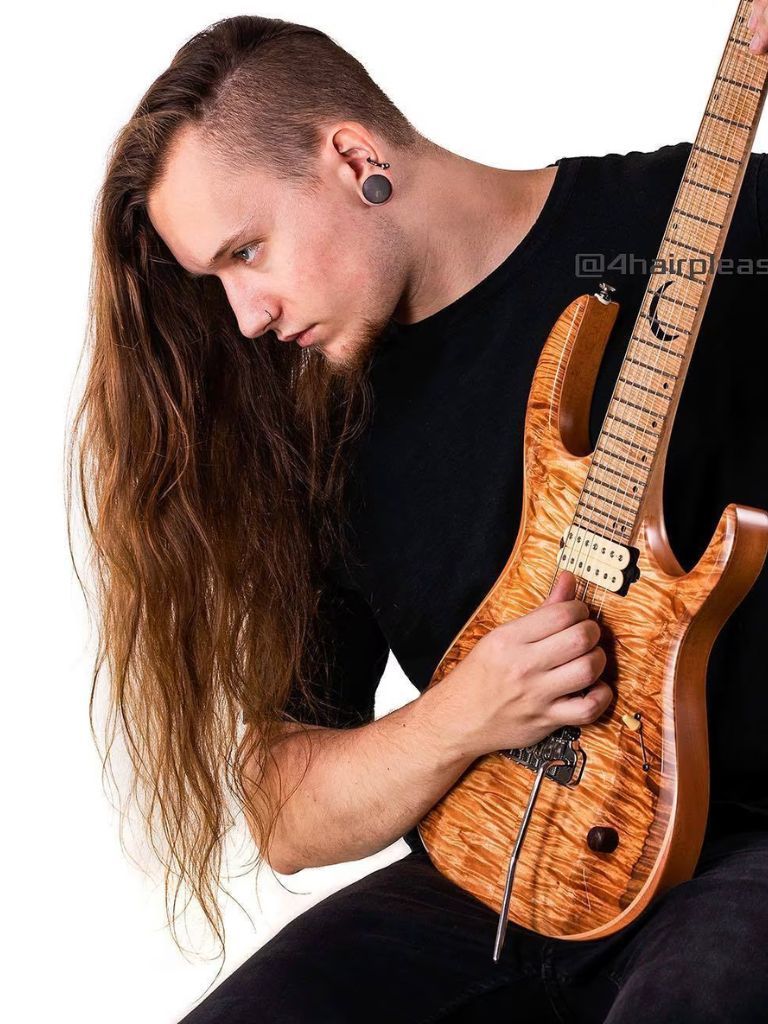 Man with extra long red hair with bold long undercut hairstyle