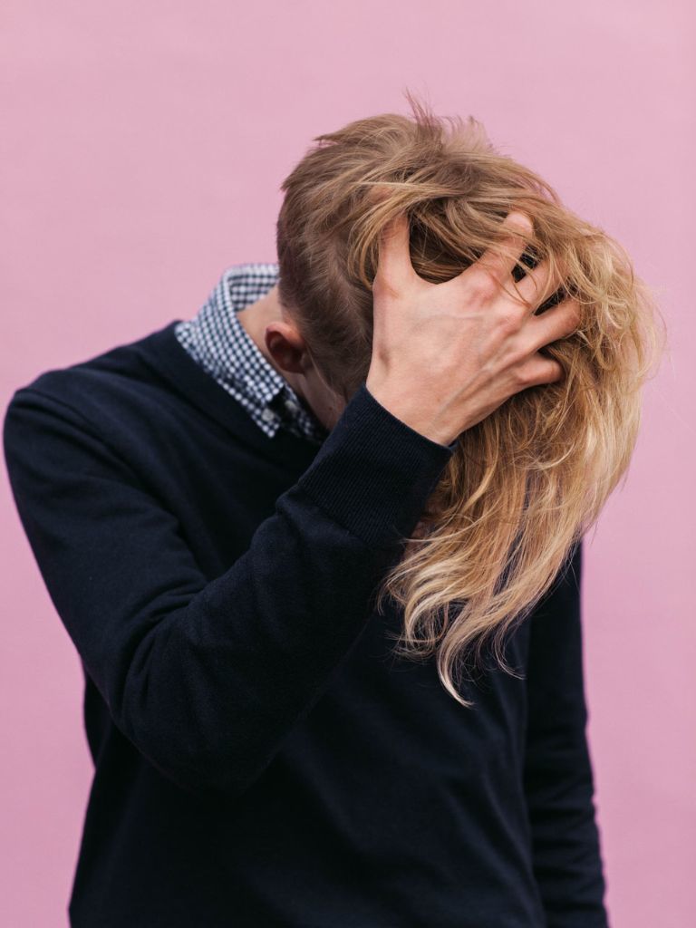 Man long blonde hair and taper undercut style