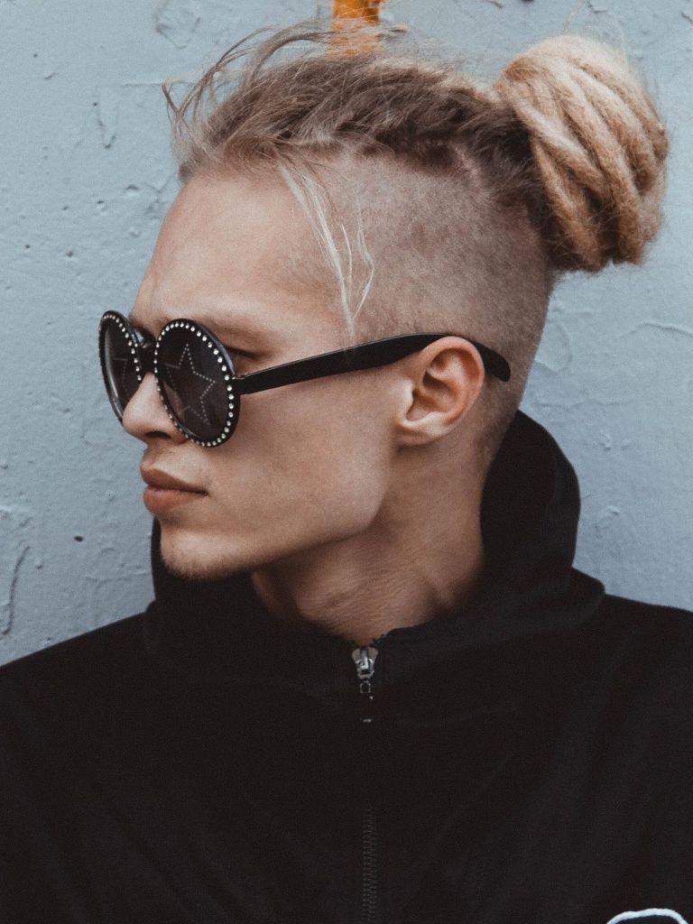 Man with long undercut and blonde dreads styled into a bun