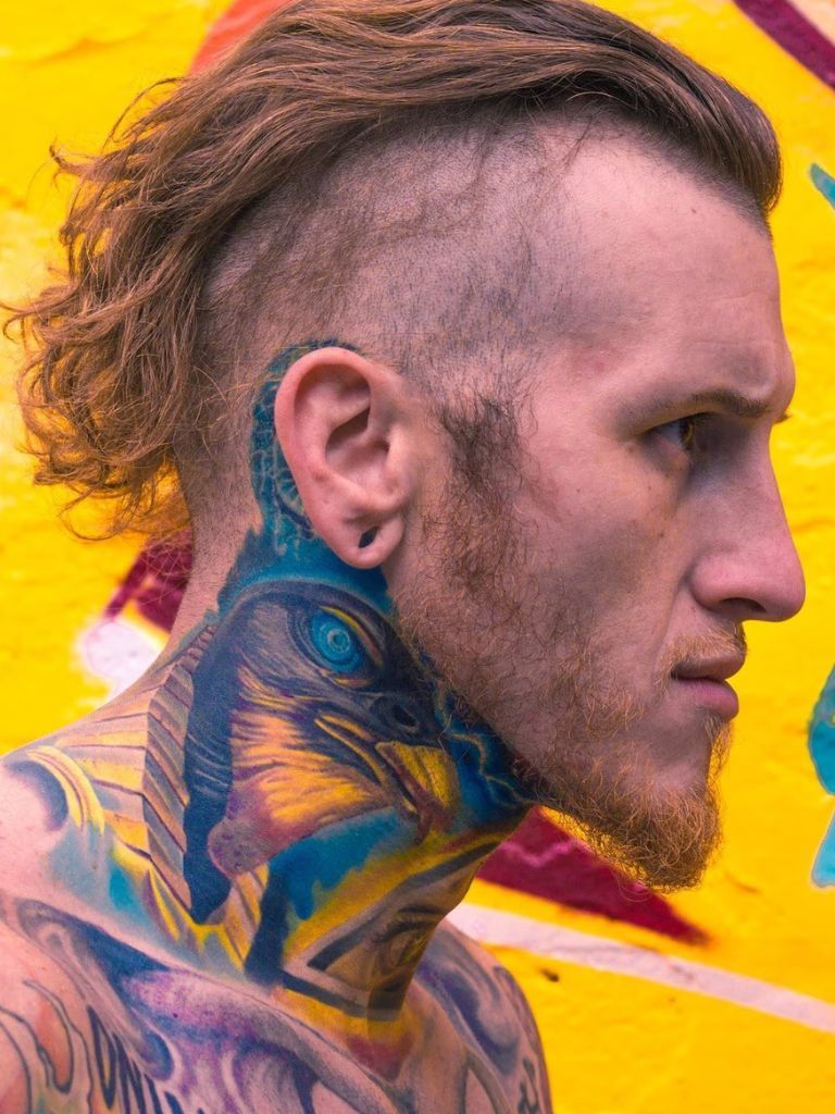 Man with dark brown long disconnected hairstyle swept backwards