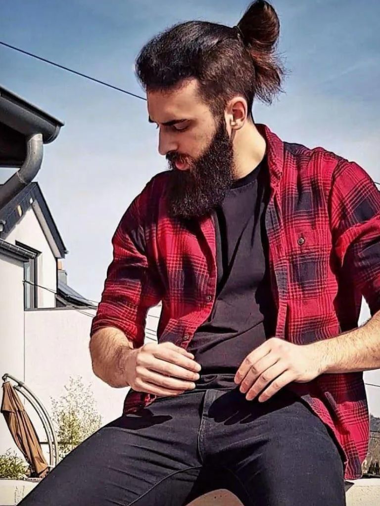 Man with an overgrown long undercut hairstyle with beard