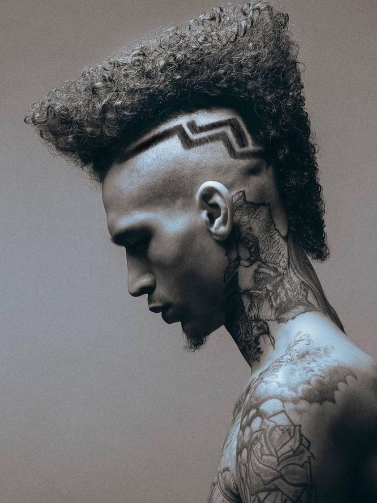 man with a patterned undercut hairstyle with natural hear