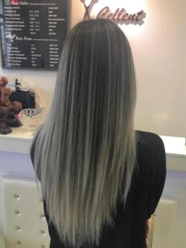 Back shot of a woman with long straight charcoal ombre hair