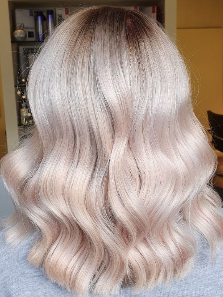Woman in hairdresser with pearl ash blonde ombre hair
