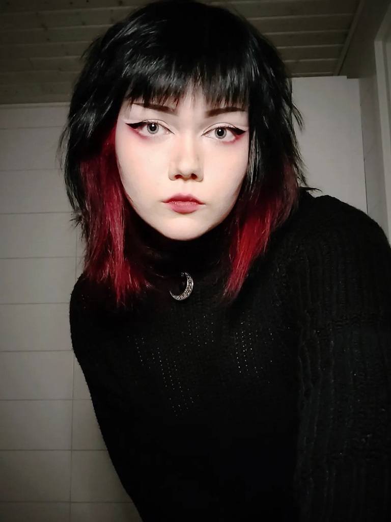 girl with black hair in a bob with red dip-dye front tips